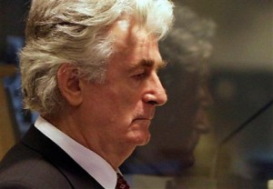 Former Bosnian Serb leader Radovan Karadzic, enters the courtroom at the International Criminal Tribunal for the Former Yugoslavia in The Hague, Netherlands, Friday Aug. 29, 2008. Karadzic refused to enter pleas to the 11 charges, including genocide and crimes against humanity, filed against him. After his refusal to plead, Presiding Judge Iain Bonomy entered not guilty pleas on his behalf. (AP Photo/ Valerie Kuypers, Pool).