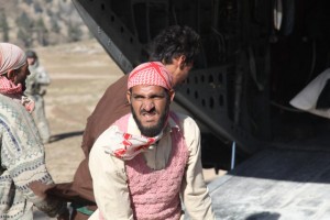 Pakistani men unload food from a U.S. Army helicopter in the Swat Valley in November 2010.